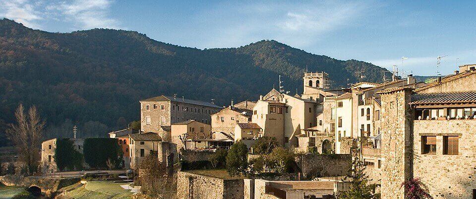 The rooftops over Besalu with mountains in the distance 